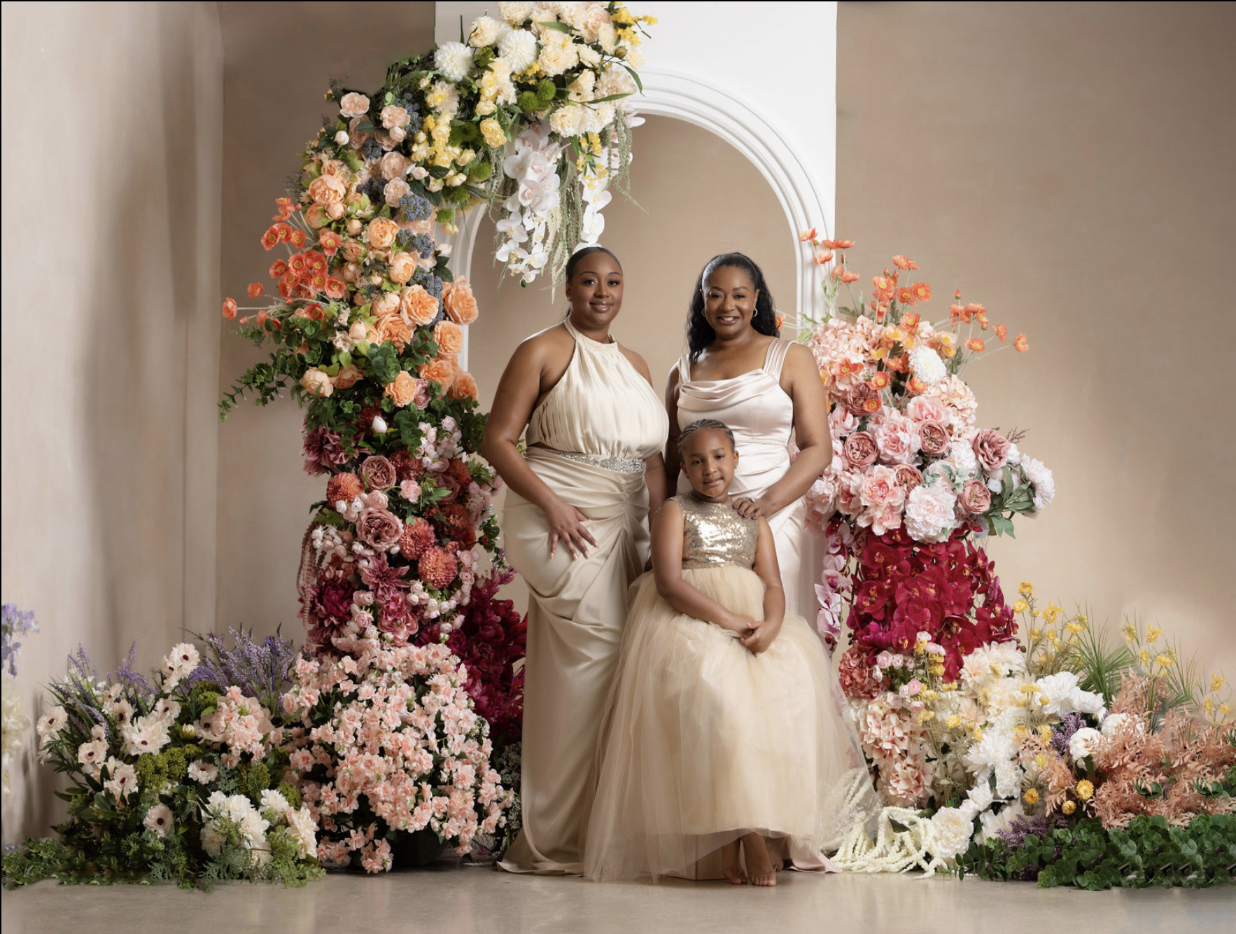 An in studio family portrait session that features a grandmother and her daughter and granddaughter