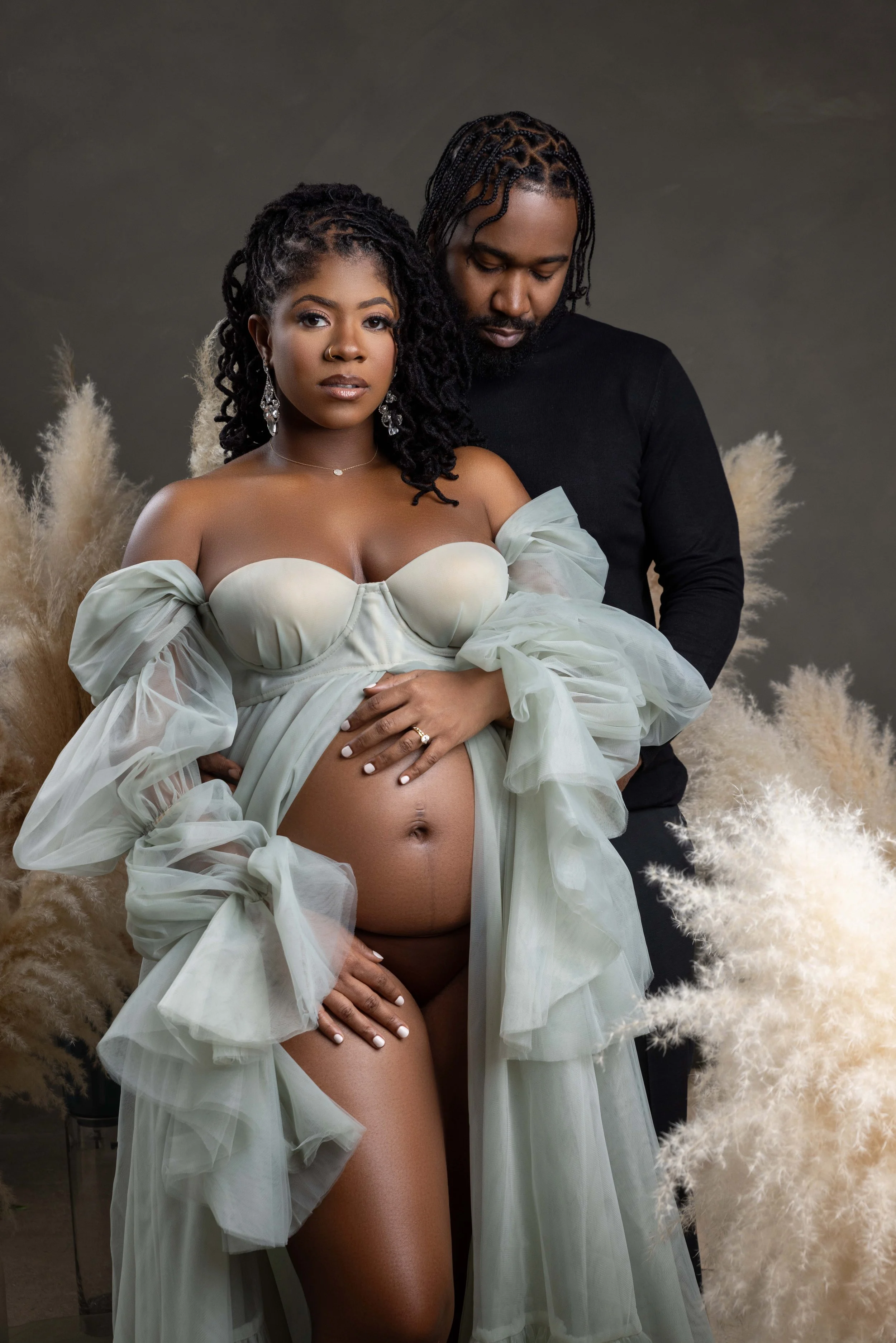 joyful maternity photography moment capturing expecting mother laughing during studio photoshoot