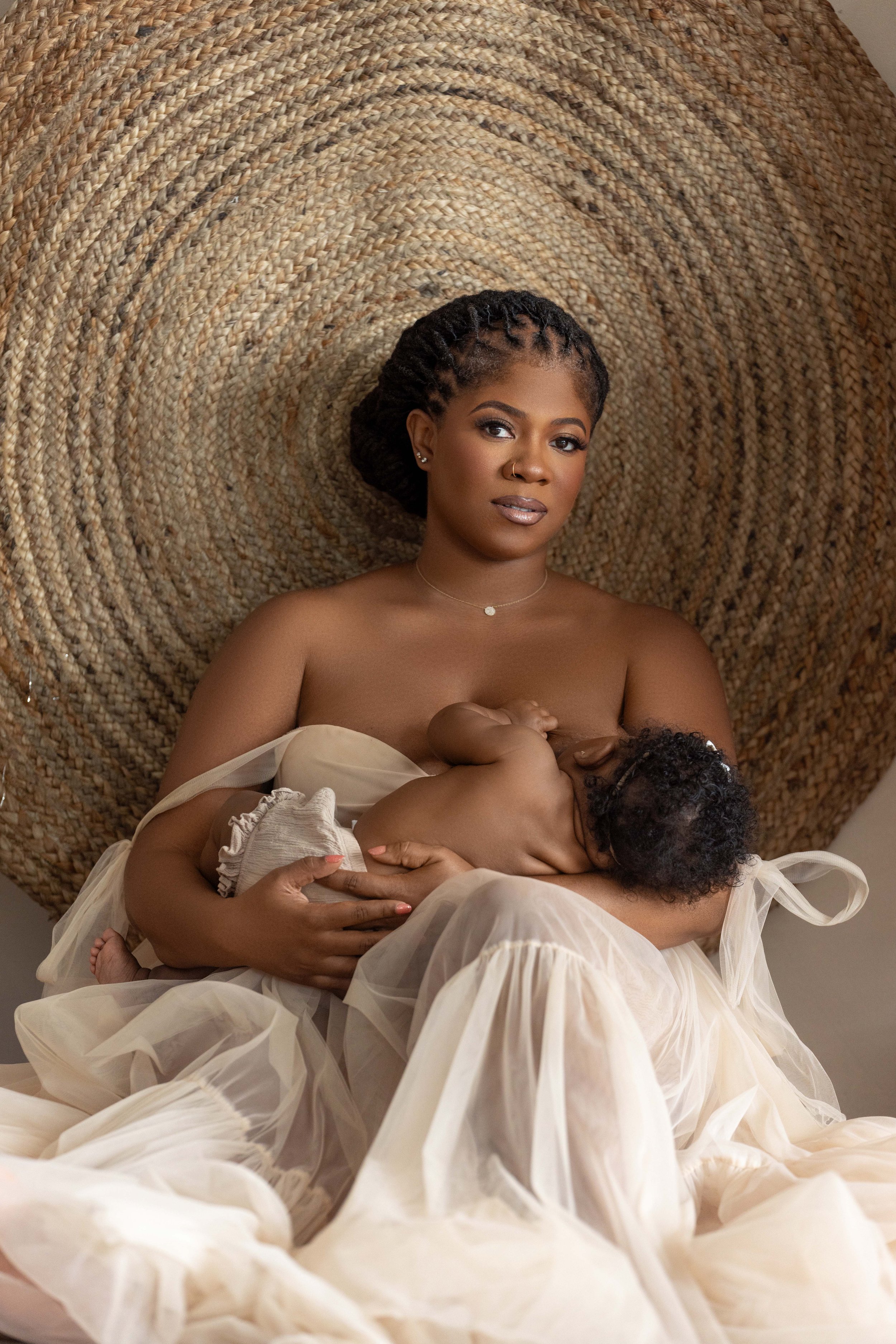 timeless motherhood portrait of mom holding newborn baby during postpartum photography session