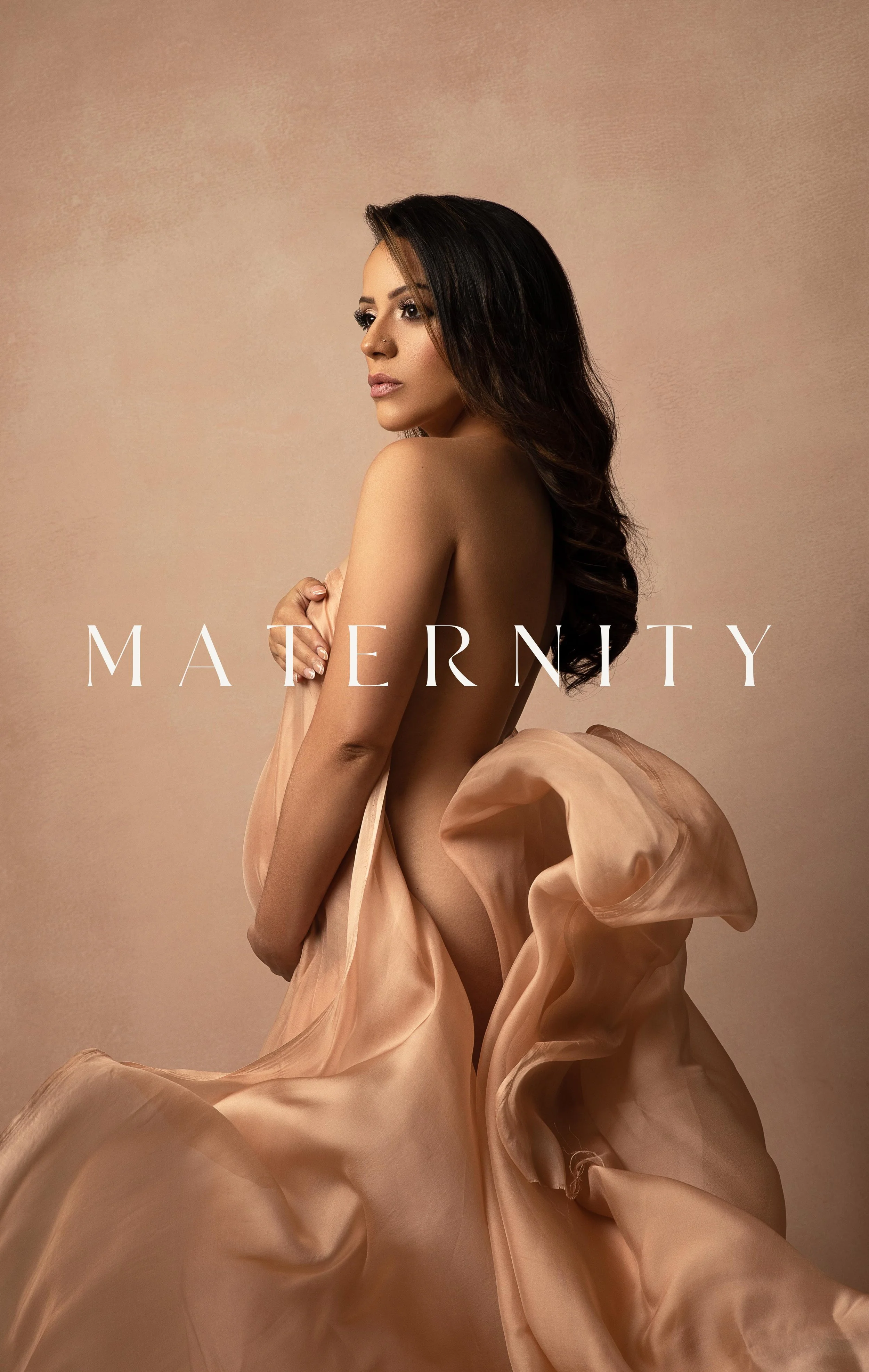 Fine Art portrait of a pregnant mother draped in silk against Oliphant canvas backdrop