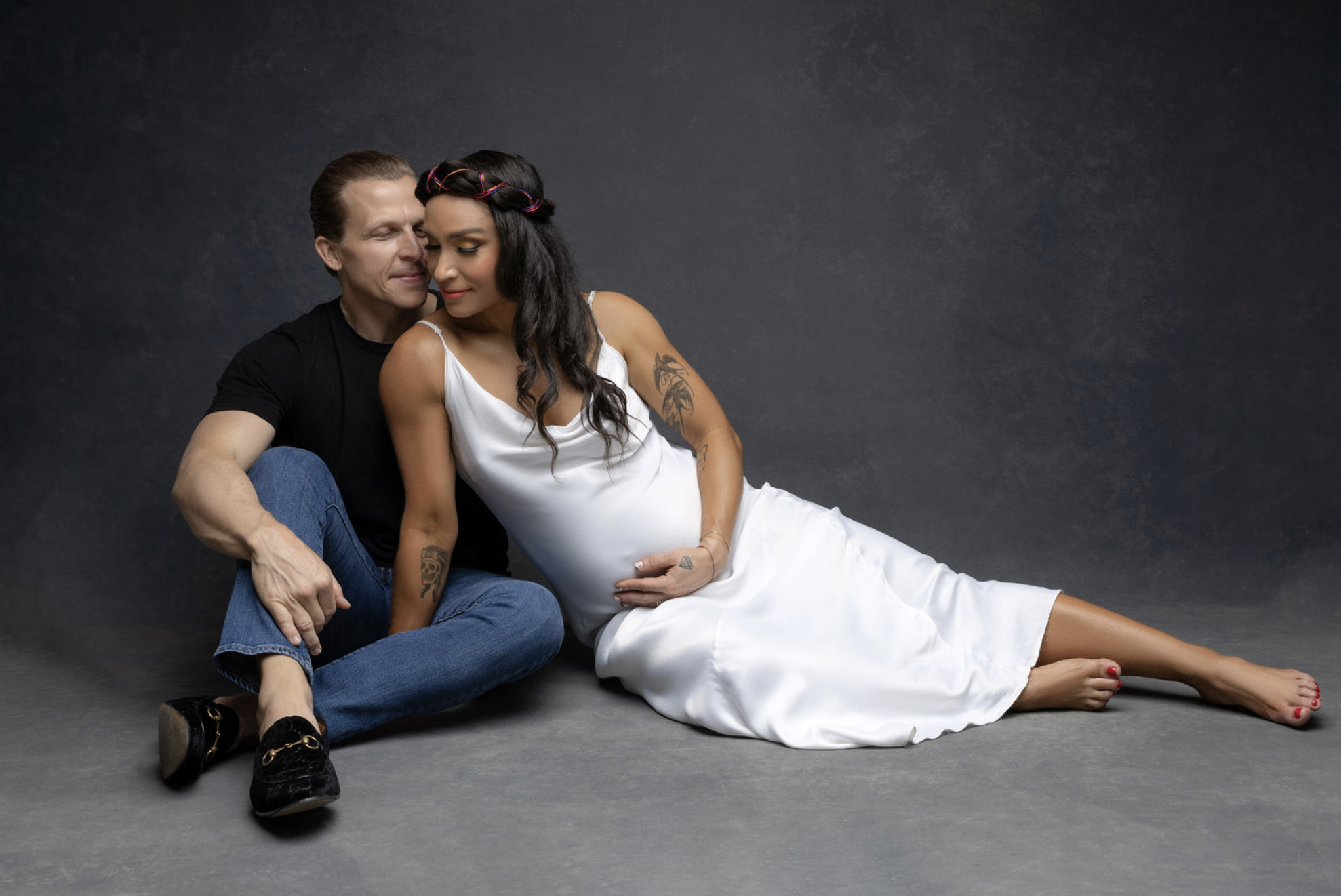 Robin Arzón and husband Drew Butler intimate maternity portrait seated on studio floor, NYC maternity photography by Candace Howe Studios Brooklyn