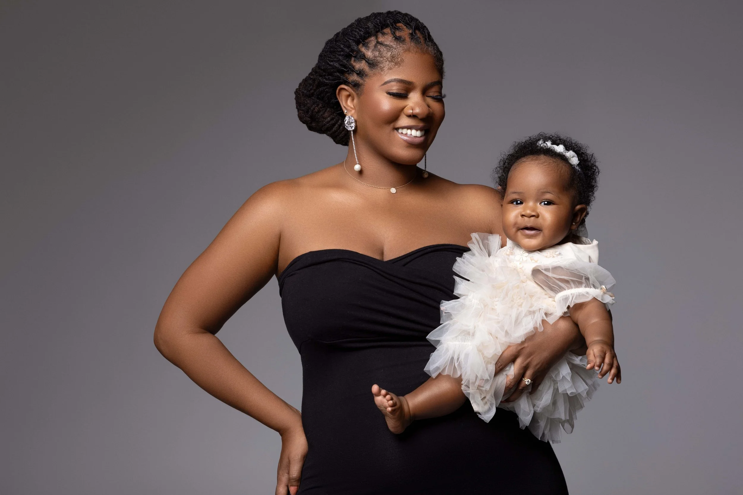 timeless motherhood portrait of mom holding newborn baby during postpartum photography session