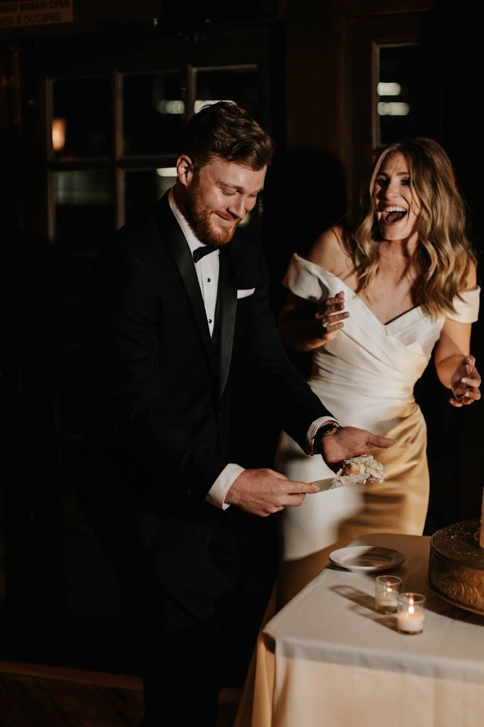 Groom wearing black tuxedo.