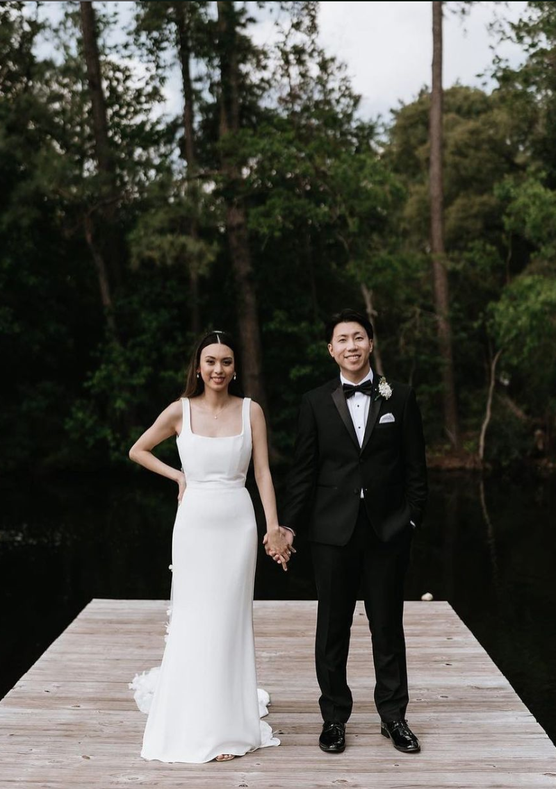 Groom in black tuxedo with black bowtie.