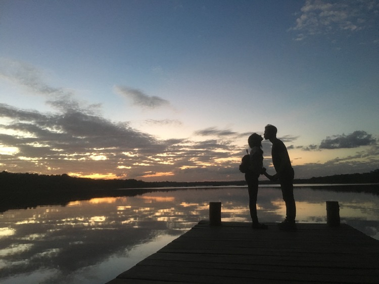 Couple kissing under sunset