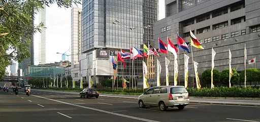 The flags of ASEAN nations raised in MH Thamrin Avenue, right in front of Japanese Embassy in Jakarta, Indonesia, during 18th ASEAN Summit, Jakarta, 8 May 2011.&nbsp;Photo: By Gunawan Kartapranata (Own work) [CC BY-SA 3.0], via Wikimedia Commons. Us…