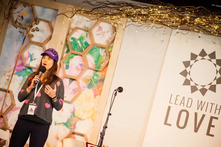 Gina Murdock speaking at a Lead With Love gathering in Aspen, Colorado