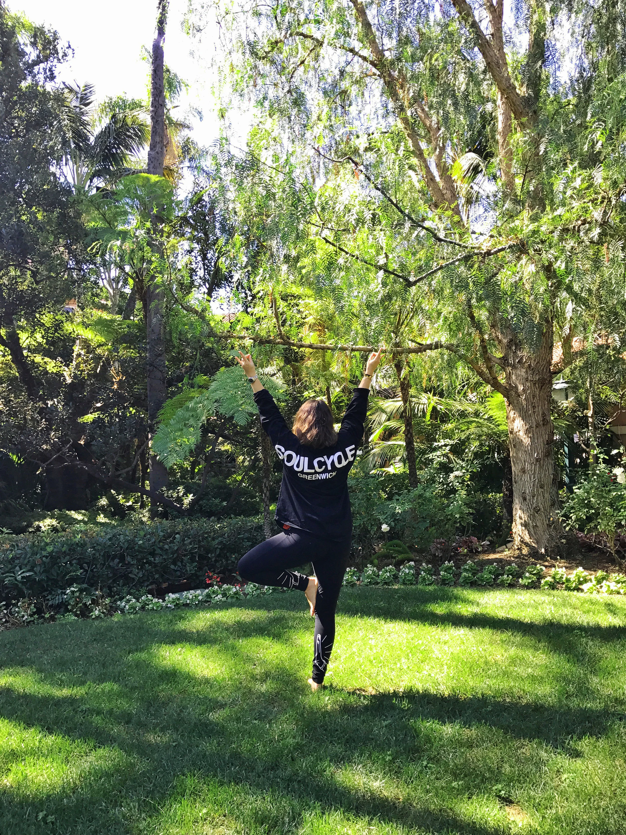 ALB in Vriksasana, Tree Pose, in the Beverly Hills Hotel garden.