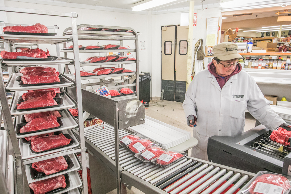 Ruth Grehl feeds meat into the machine