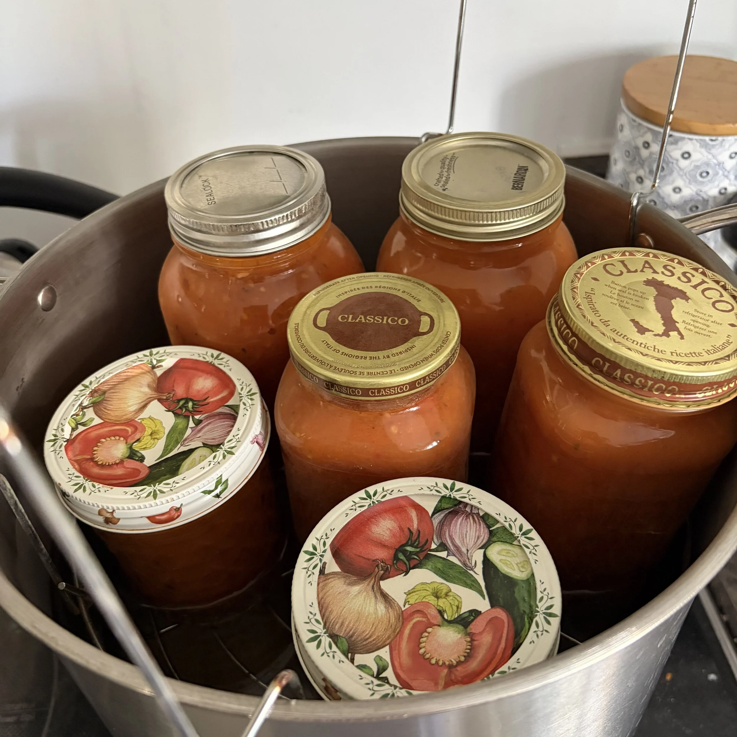 Jars of canned tomatoes in a large water bath pot