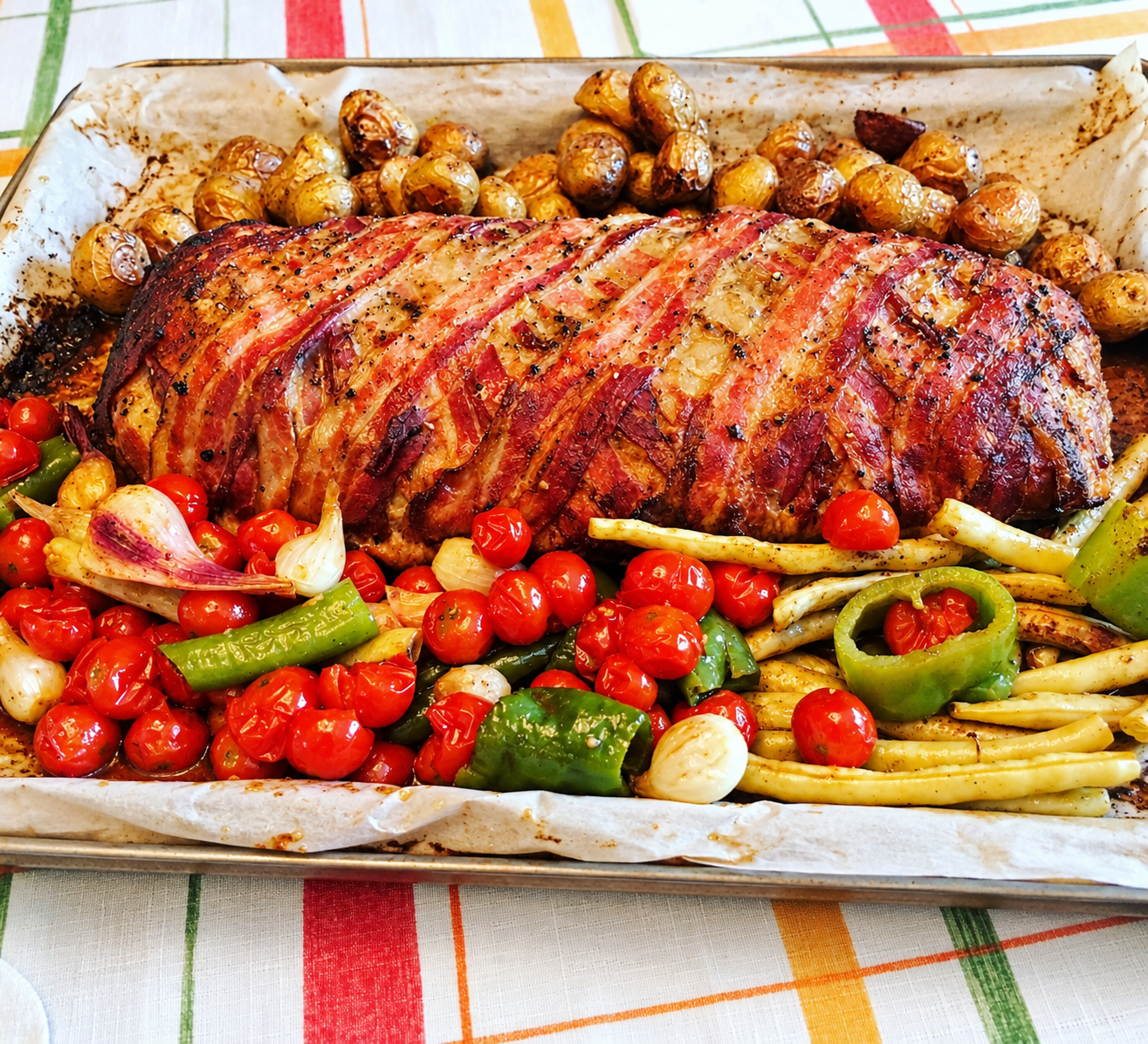 Bacon wrapped gluten free meatloaf with roasted vegetables on the side