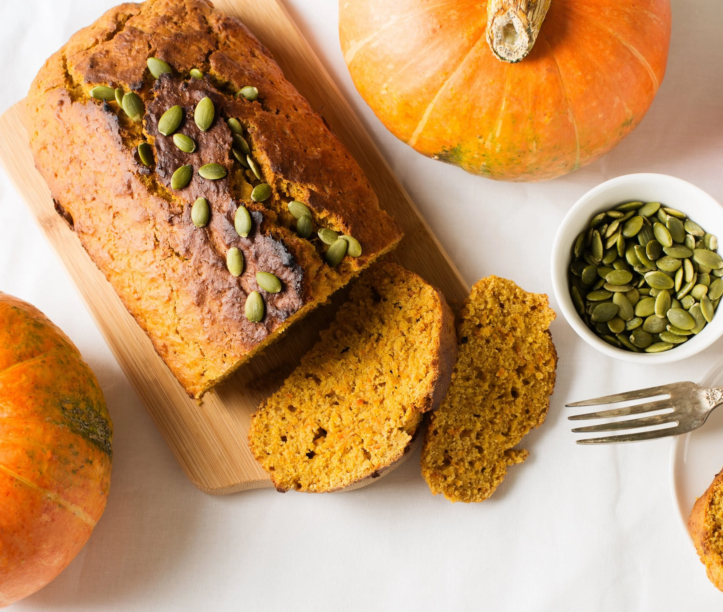 Olive oil pumpkin bread fresh from the oven, topped with pearl sugar, with a golden crust and moist, tender crumb.