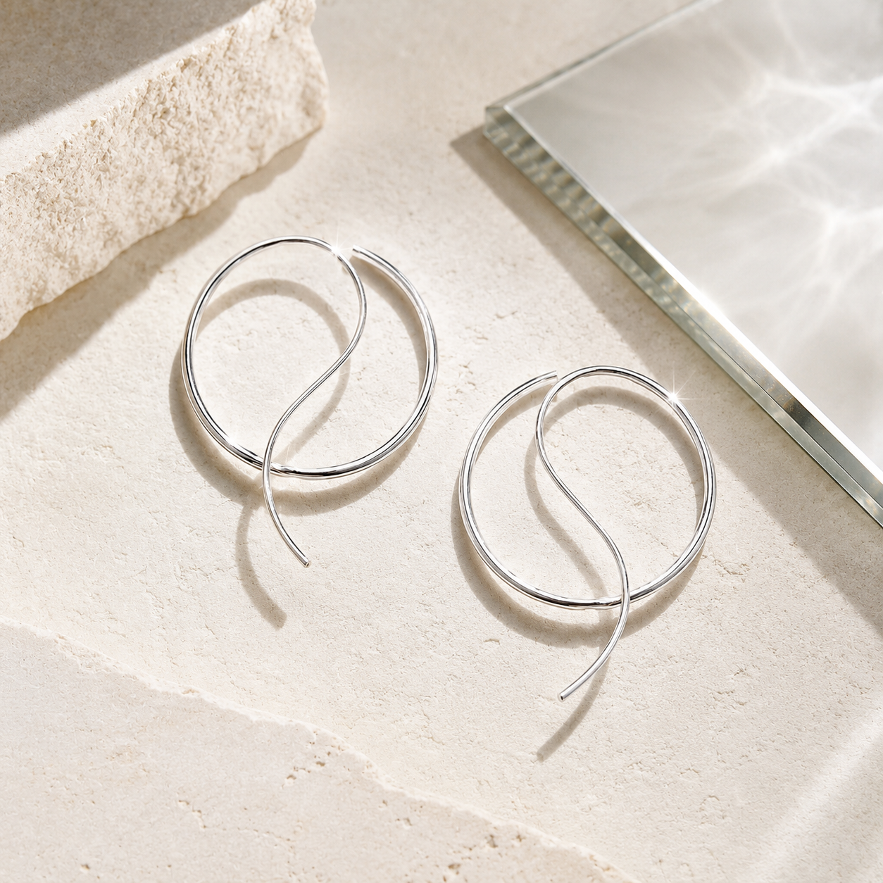 Harah Silver Hoops on table.png