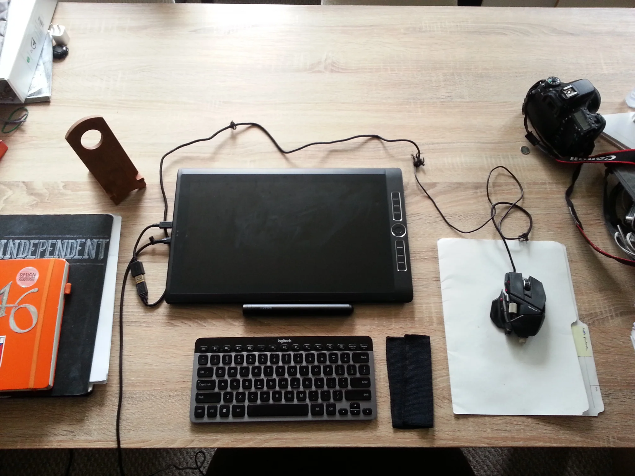 Without the stand: 'tis a bit flat. Good for the lap! It comes with a nice little shammy because touch screens get plenty greasy (or maybe I should not eat chips and then use the computer), and it comes with a lovely, though somewhat over-designed pen case. Keep your eyes off the ratty state of my mouse cable. 