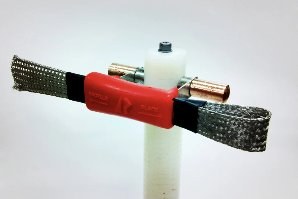 A thing of beauty! Joe sent me this pic of the final device mounted on it's HDPE insulating rod. The whole thing is mounted on the the hub of the turbine and rotates with the blades. The tail at left constantly contacts a grounding surface on the nacelle as the hub rotates; the right side contacts the base of the blade and allows it to turn relative to the hub as the blade changes pitch with different wind speeds. (Do I need to draw a diagram?) Way better than hose clamps and electrical tape.