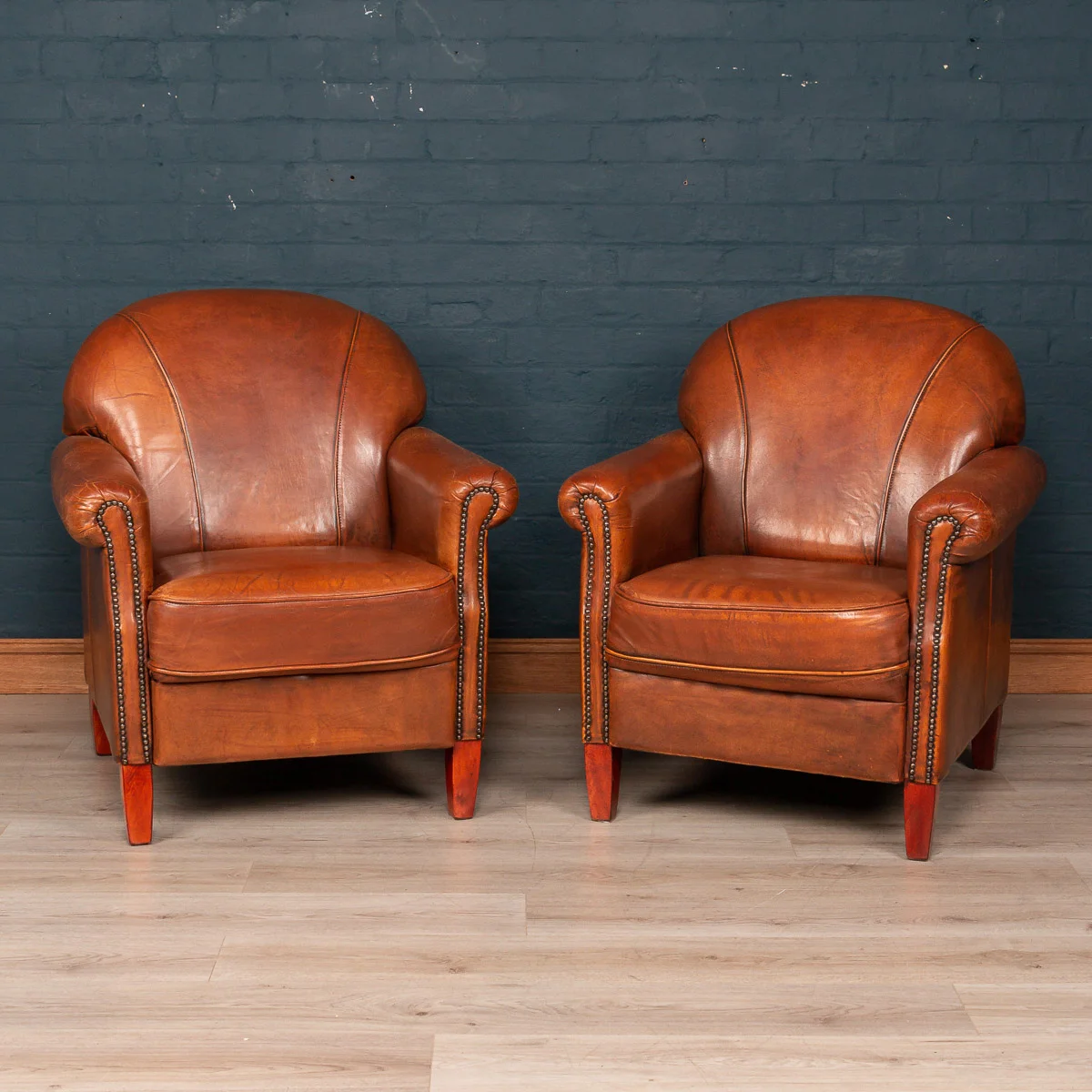 A pair of sheepskin leather tub chairs, Holland, late 20th century