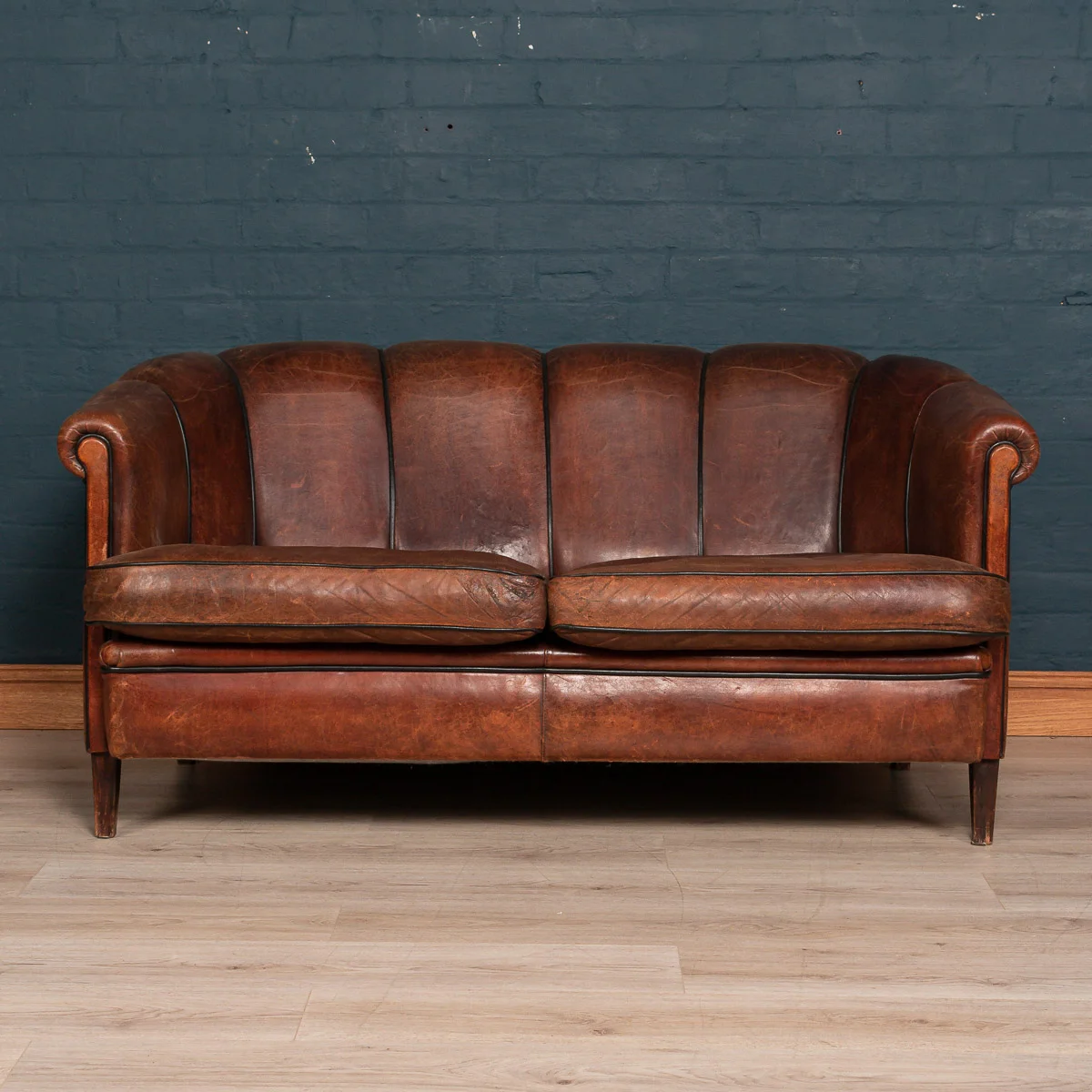 A scallop back two seater sofa in sheepskin leather, Holland, late 20th century