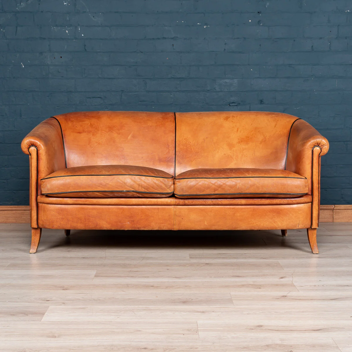 A two seater tan leather sofa, Holland, late 20th century