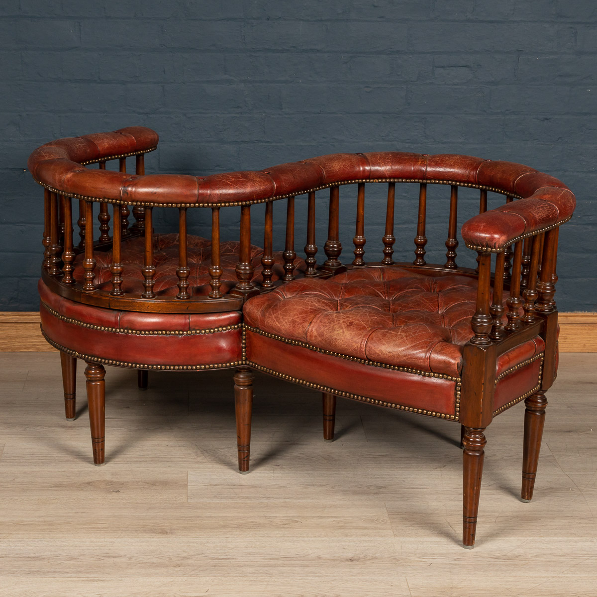 A leather "conversation seat", England, mid 20th century