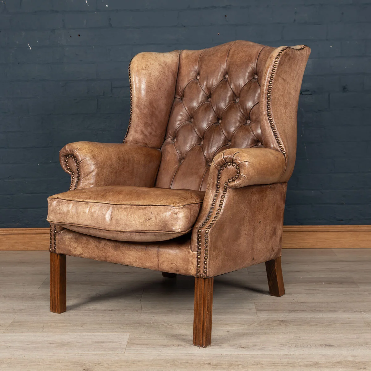 A leather wing back armchair, England, late 20th century
