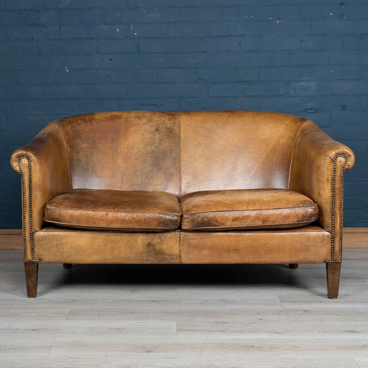 A two seater tan leather sofa, Holland, late 20th century