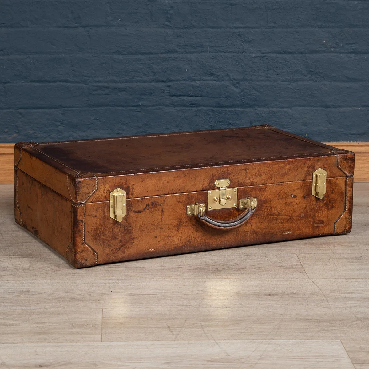 A leather suitcase in natural cow hide by Hermes, France, circa 1900