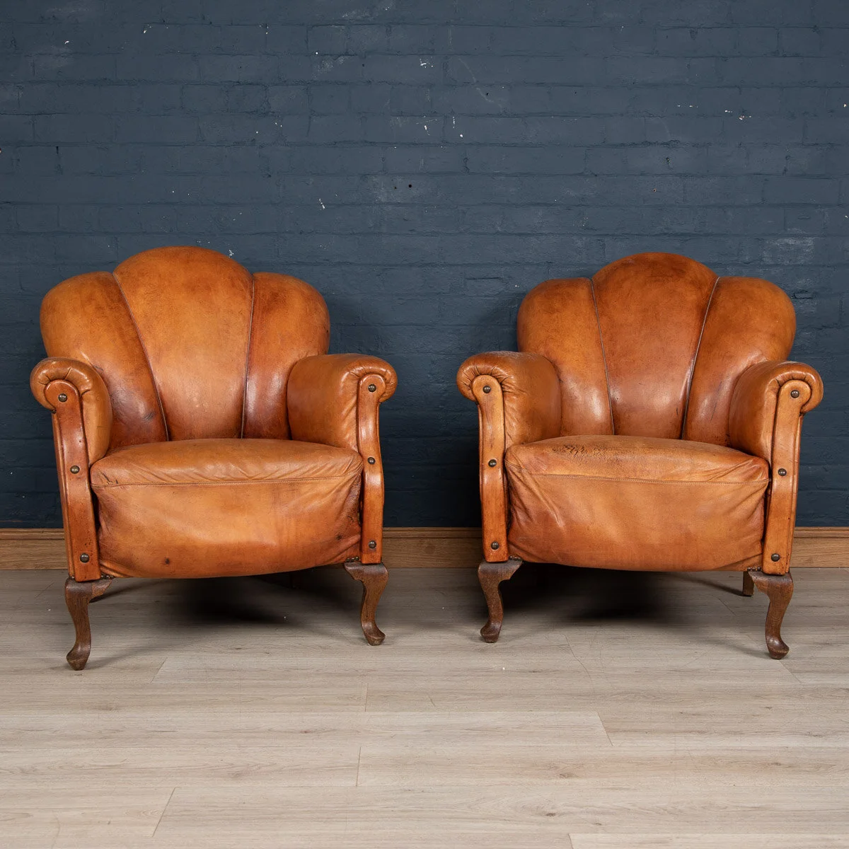 A pair of leather "scallop back" club chairs, Holland, mid to late 20th century