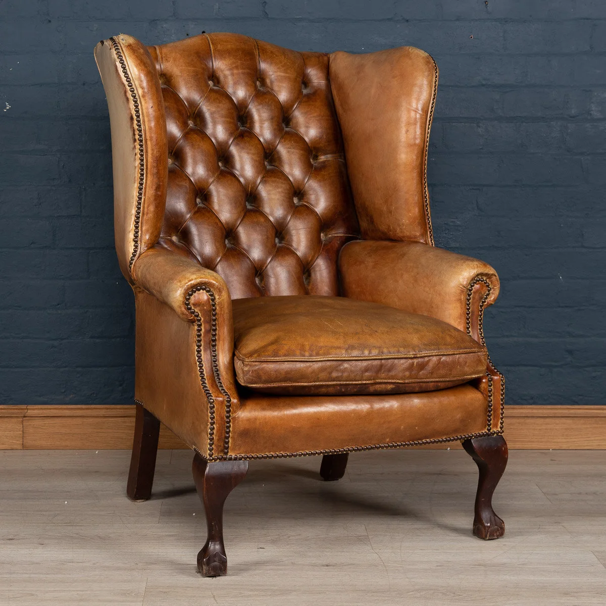 A leather wing back chair, England, mid 20th century