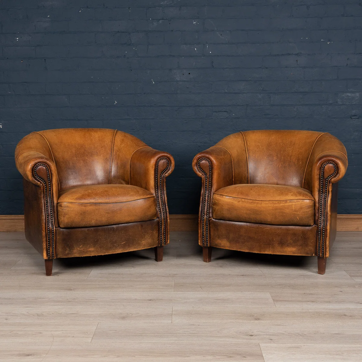 A pair of sheepskin leather tub chairs, Holland, late 20th century