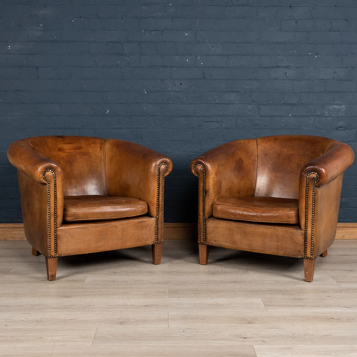 A pair of sheepskin leather tub chairs, Holland, late 20th century