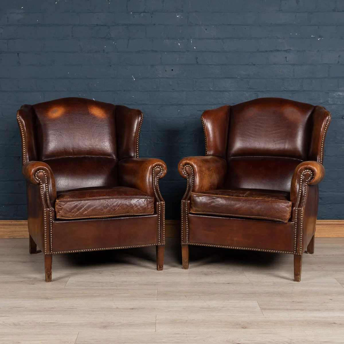 A pair of leather wing back chairs, Holland, late 20th century
