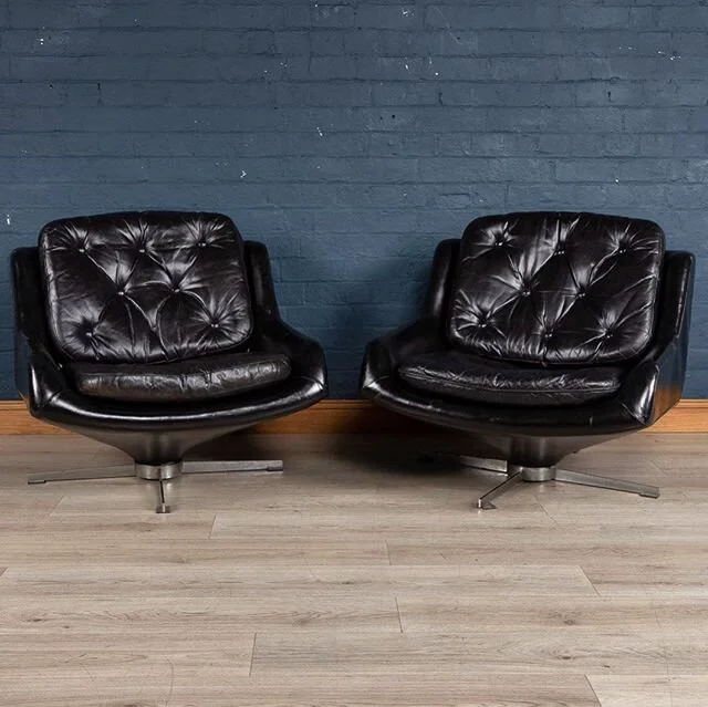 A wonderful pair of lounge armchairs with a swivel mechanism, probably Italian. The fibreglass structure has been covered in superb quality black leather and is supported by a chromed foot. On top rests loose black leather buttoned back and seat cush