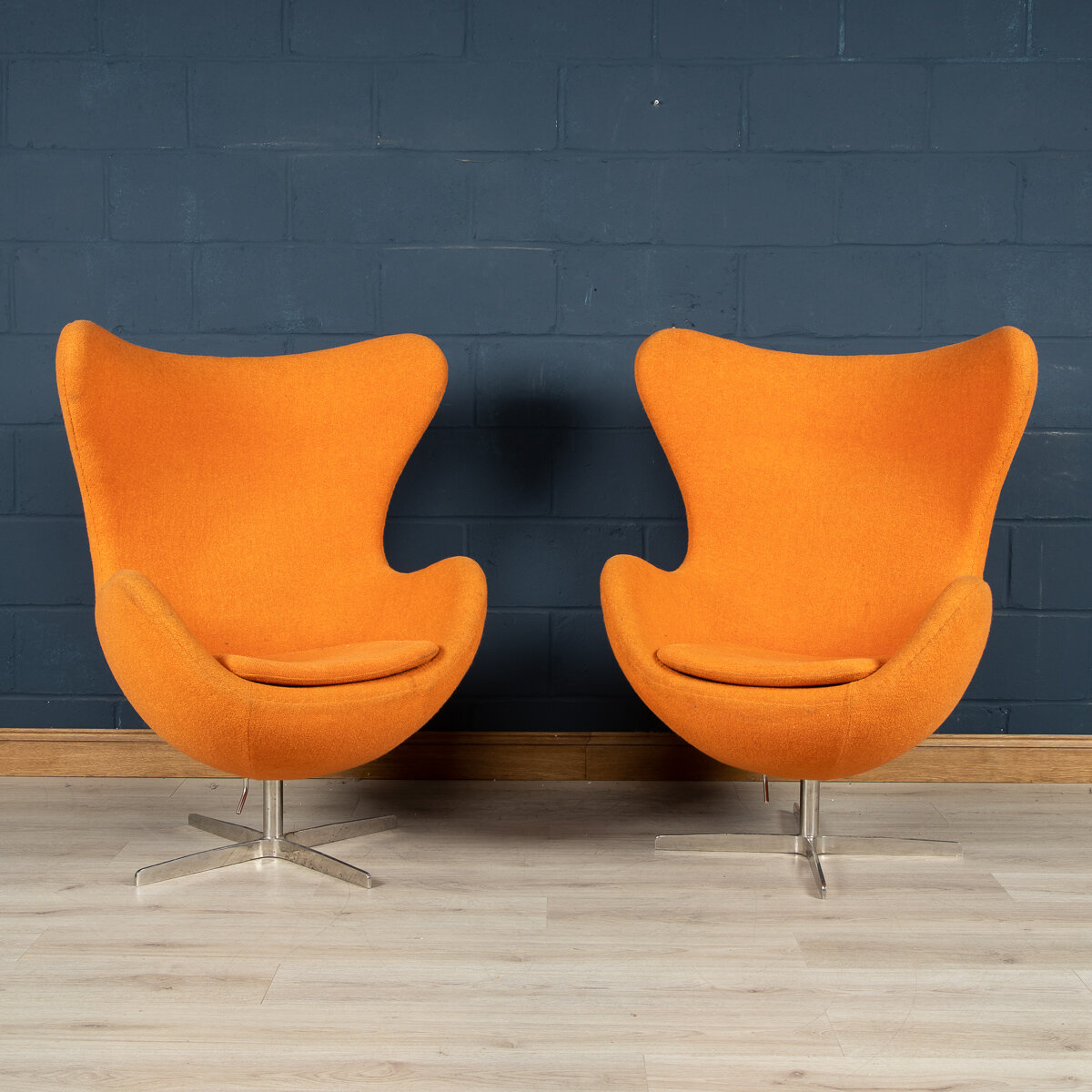 A pair of Arne Jacobsen style egg chairs, European manufacture, circa 1970