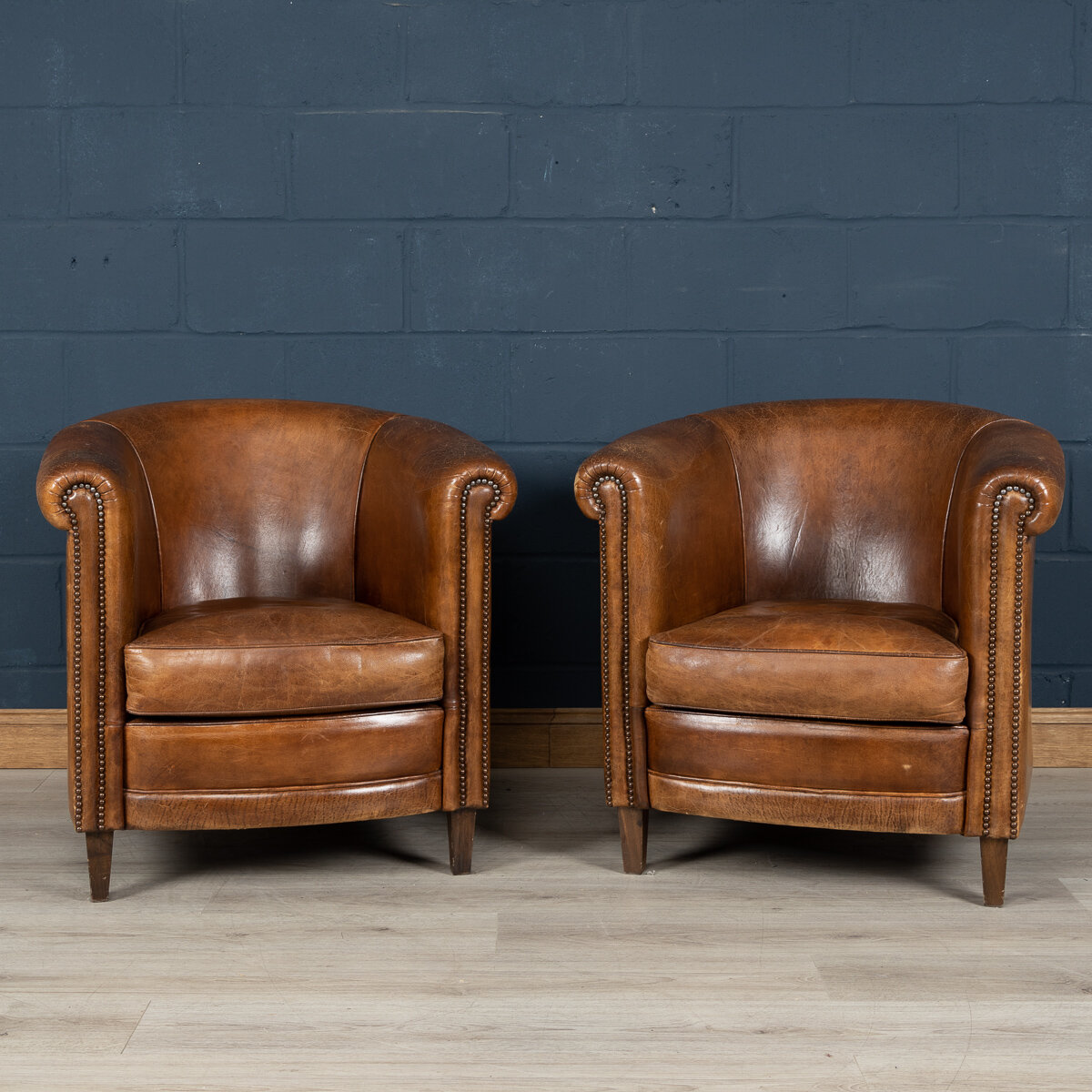 A pair of sheepskin leather tub chairs, Holland, late 20th century