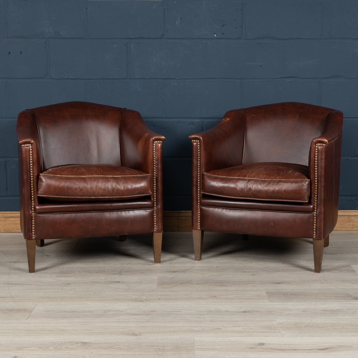 A pair of dark sheepskin leather tub chairs, Holland, late 20th century