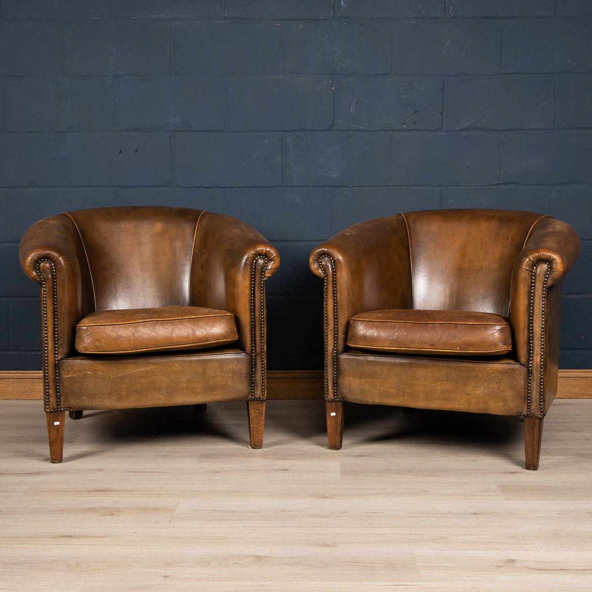 A pair of sheepskin leather tub chairs, Holland, late 20th century