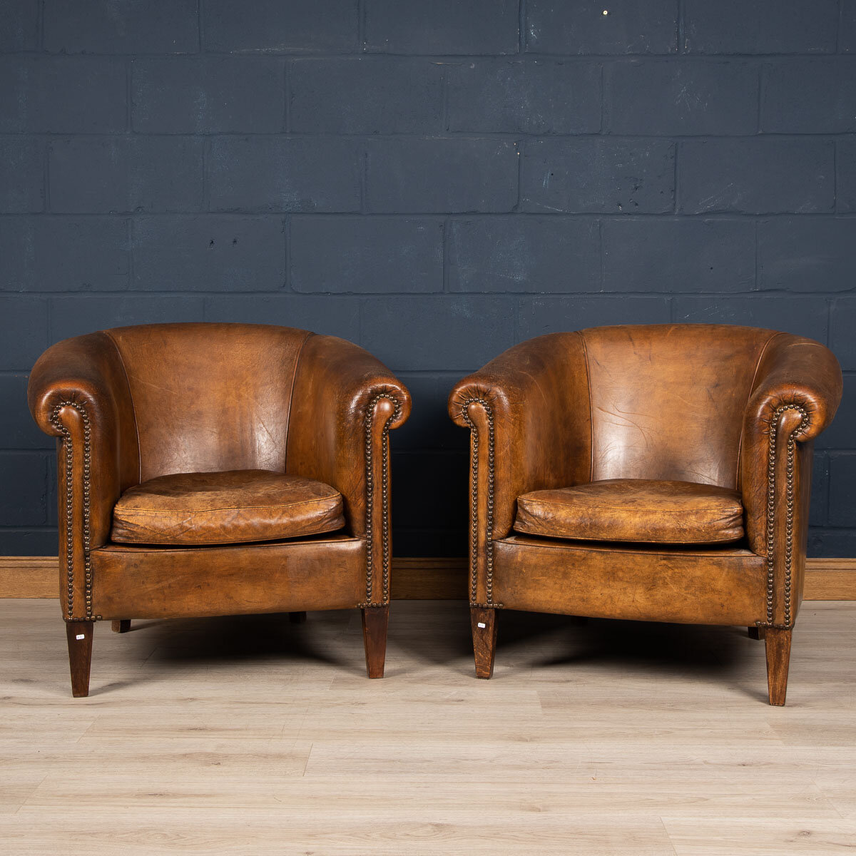 A pair of sheepskin leather tub chairs, Holland, late 20th century