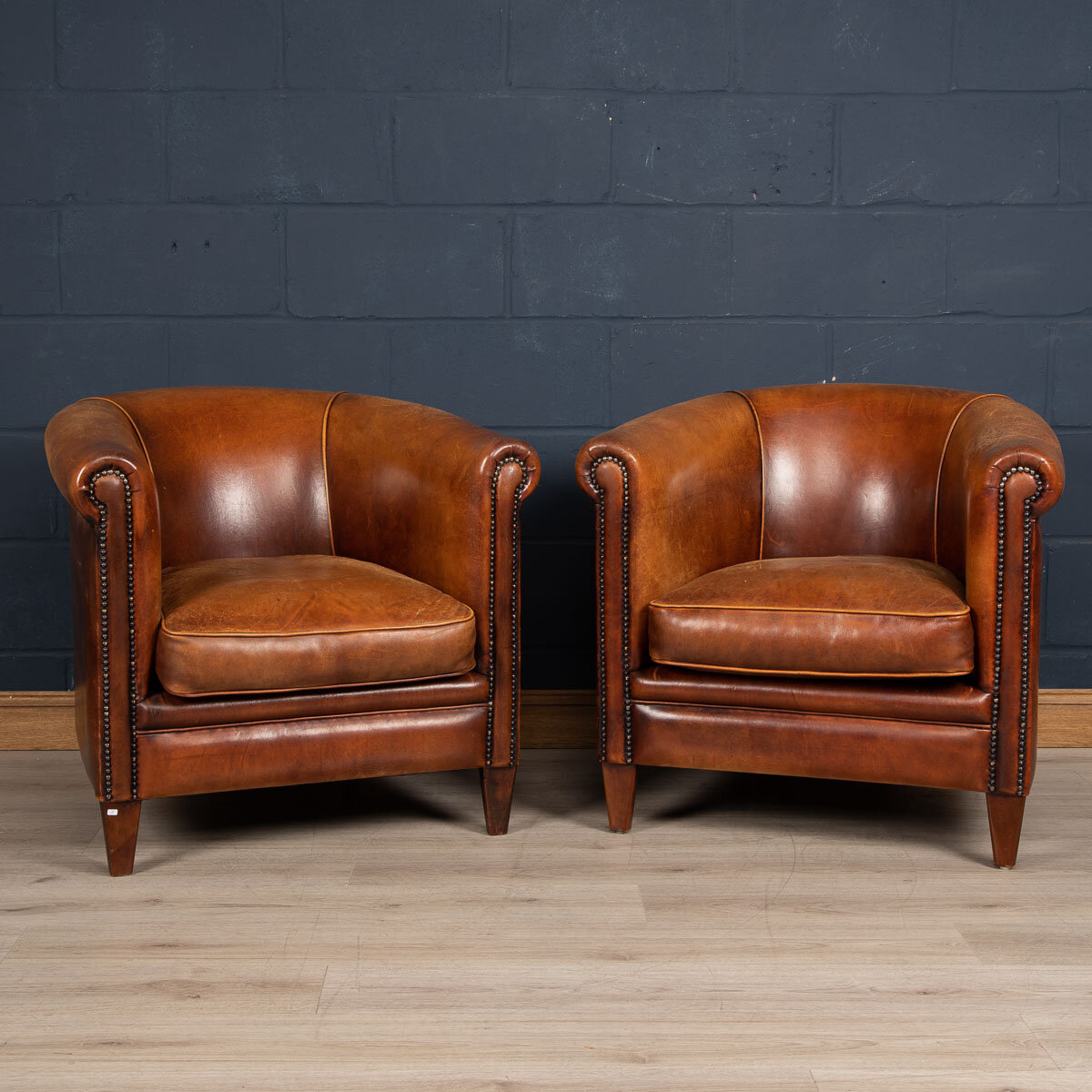 A pair of sheepskin leather tub chairs, Holland, late 20th century