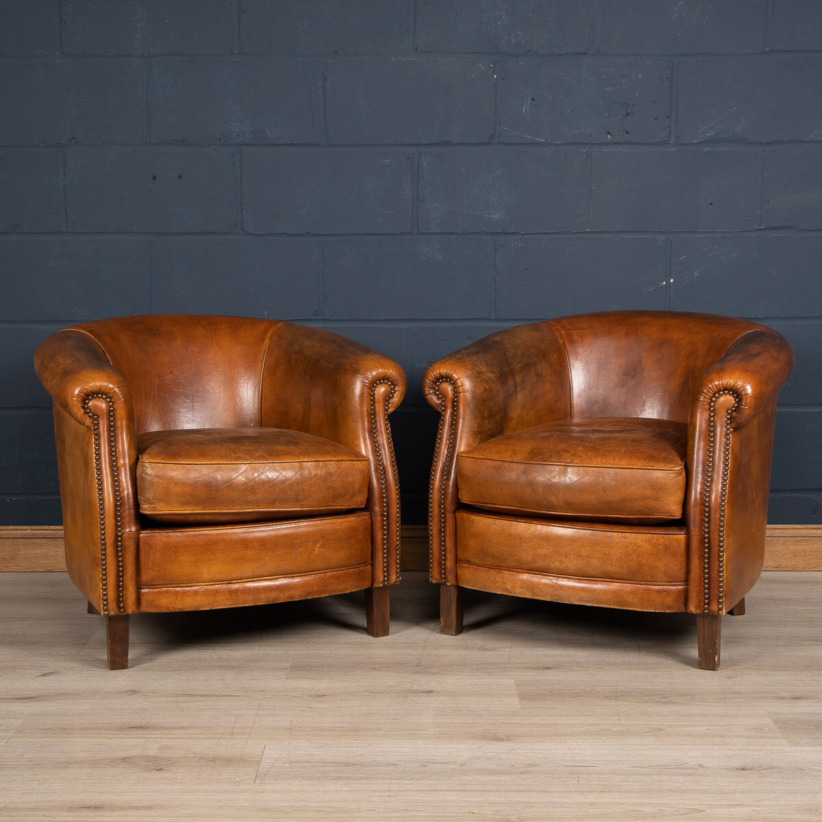 A pair of sheepskin leather tub chairs, Holland, late 20th century