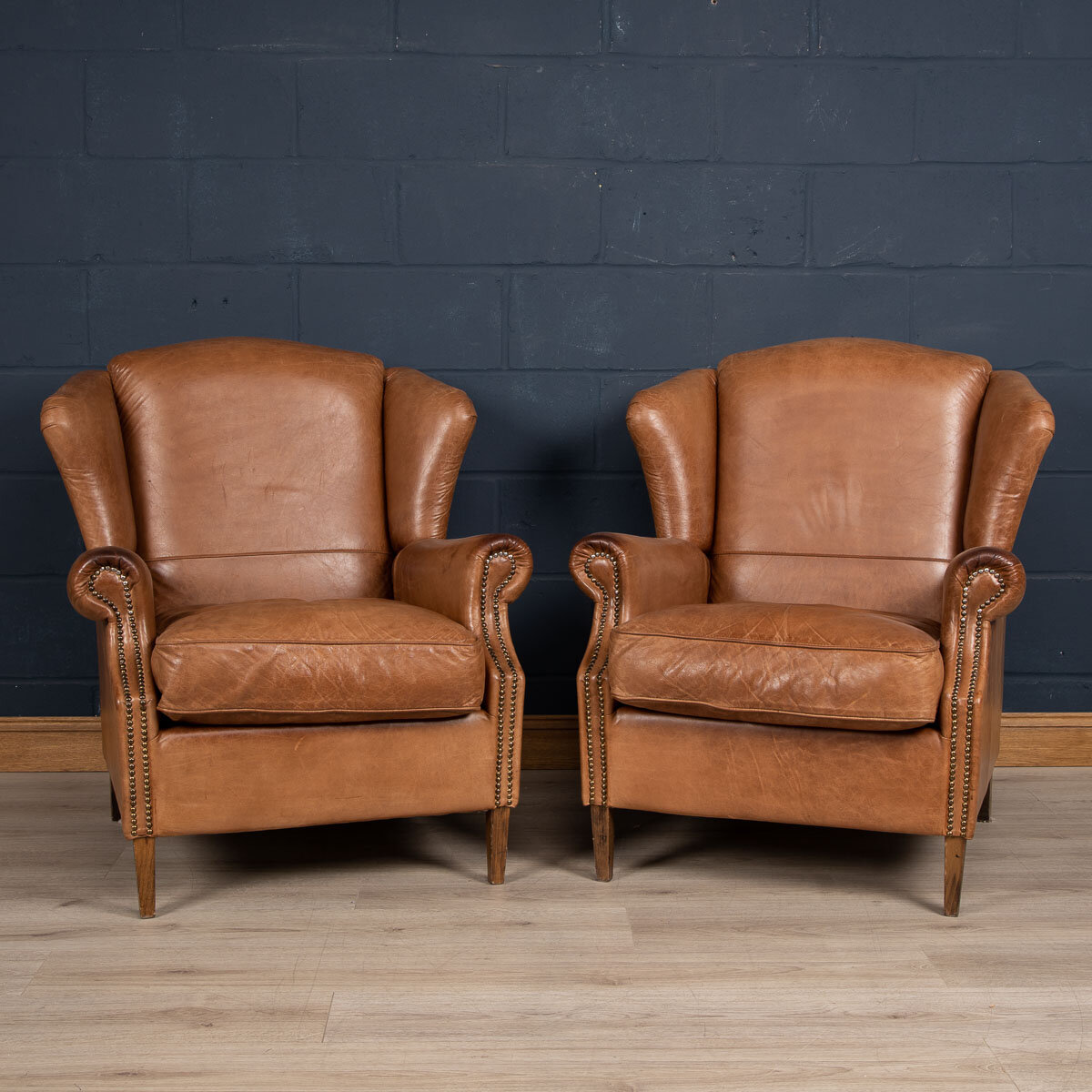 A pair or leather wing-back chairs, Holland, late 20th century