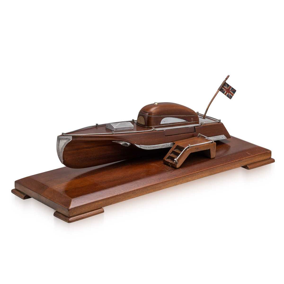 A mahogany cigarette dispenser in the form of a speed boat, England, circa 1920