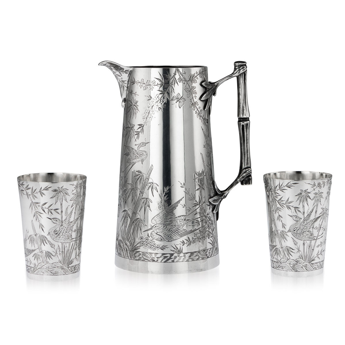 A Victorian aesthetic movement solid silver jug and beakers, Lodnon, 1883