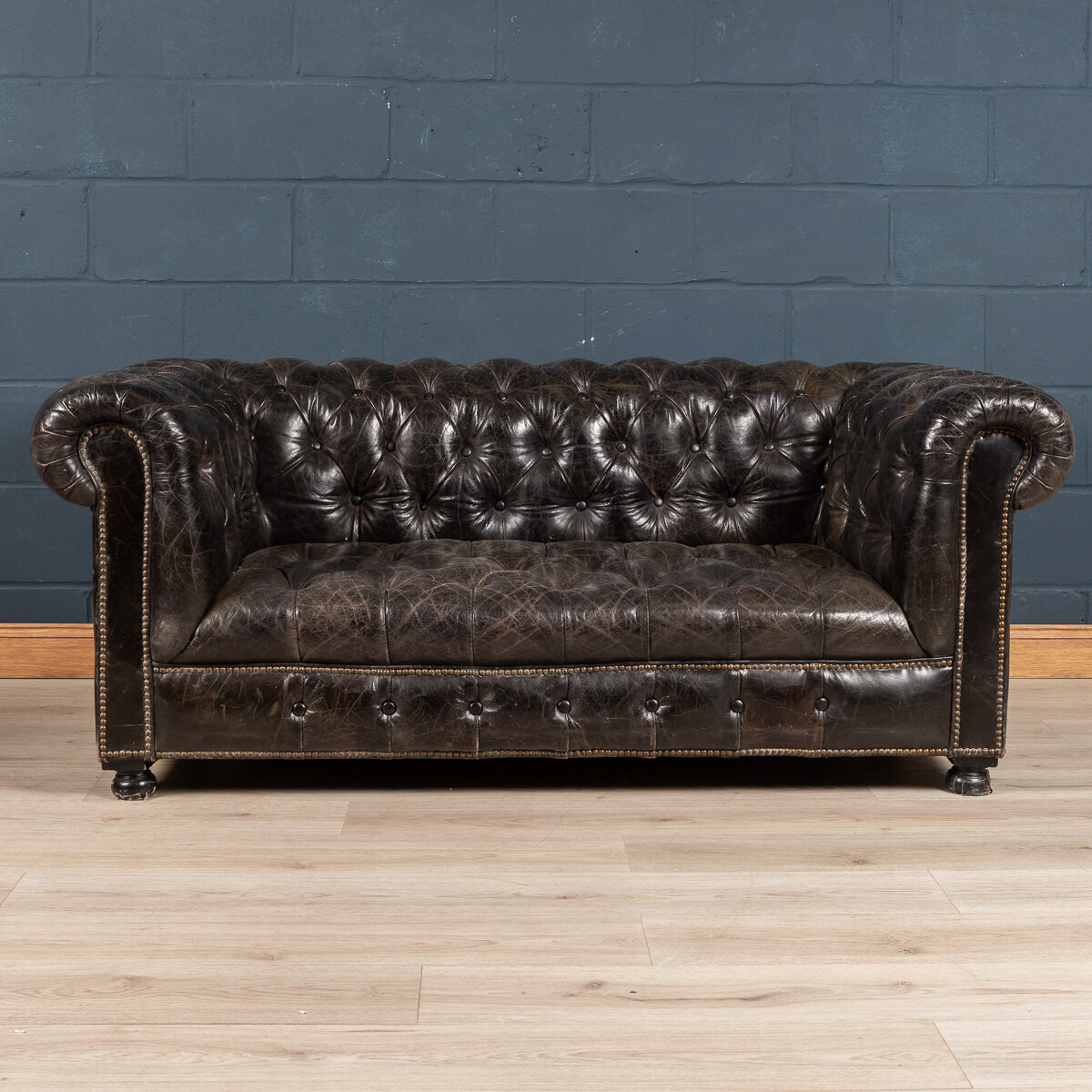 A black leather Chesterfield sofa, England, mid to late 20th century