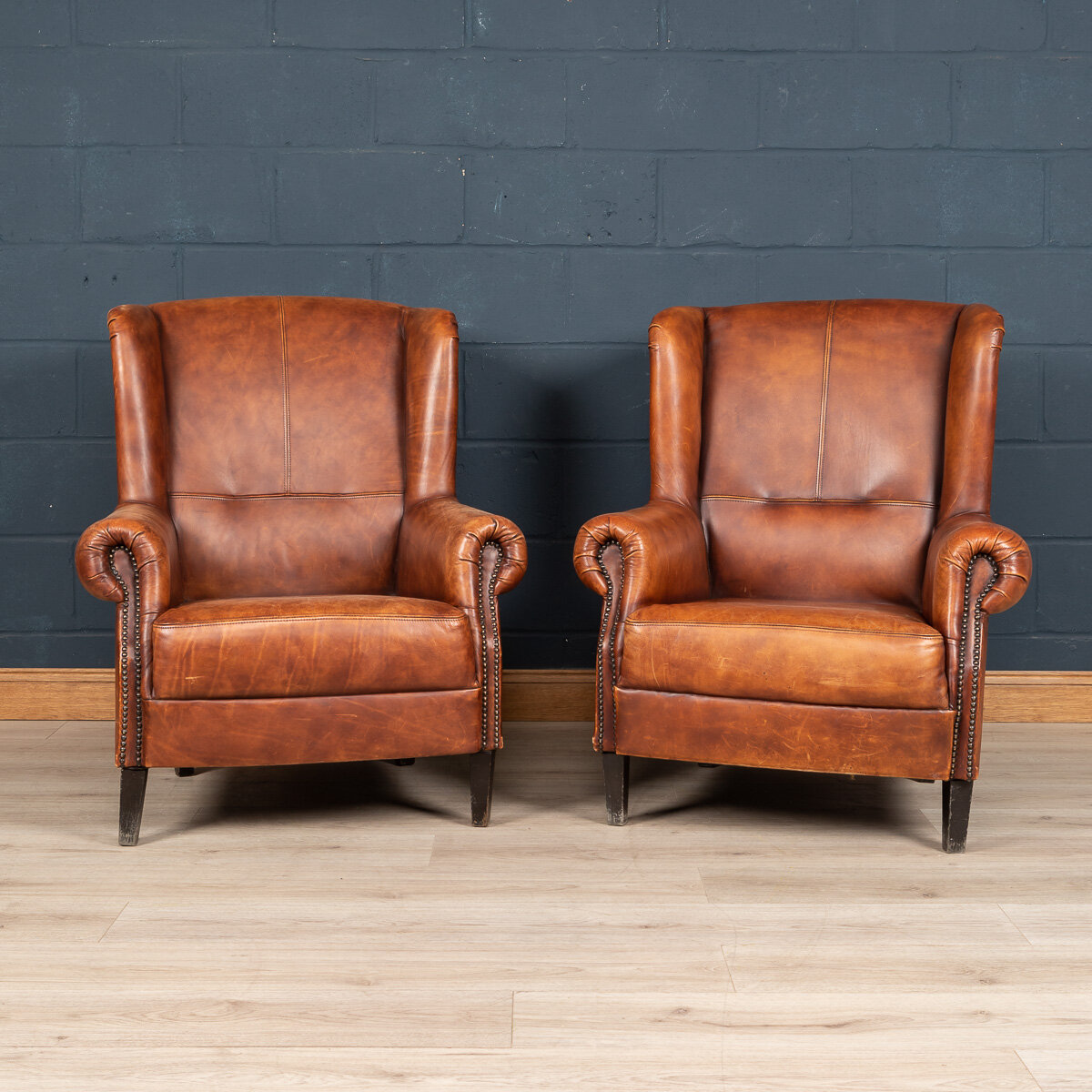 A pair of leather wing back chairs, Holland, late 20th century