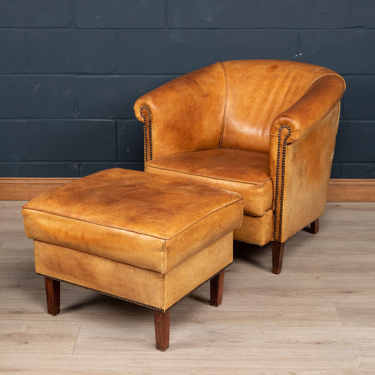 A sheepskin leather tub chair and footstool, Holland, late 20th century
