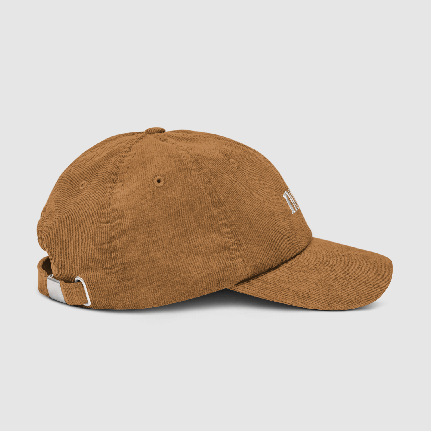 Angled close-up of front panel and brim of the camel Nope embroidered cap