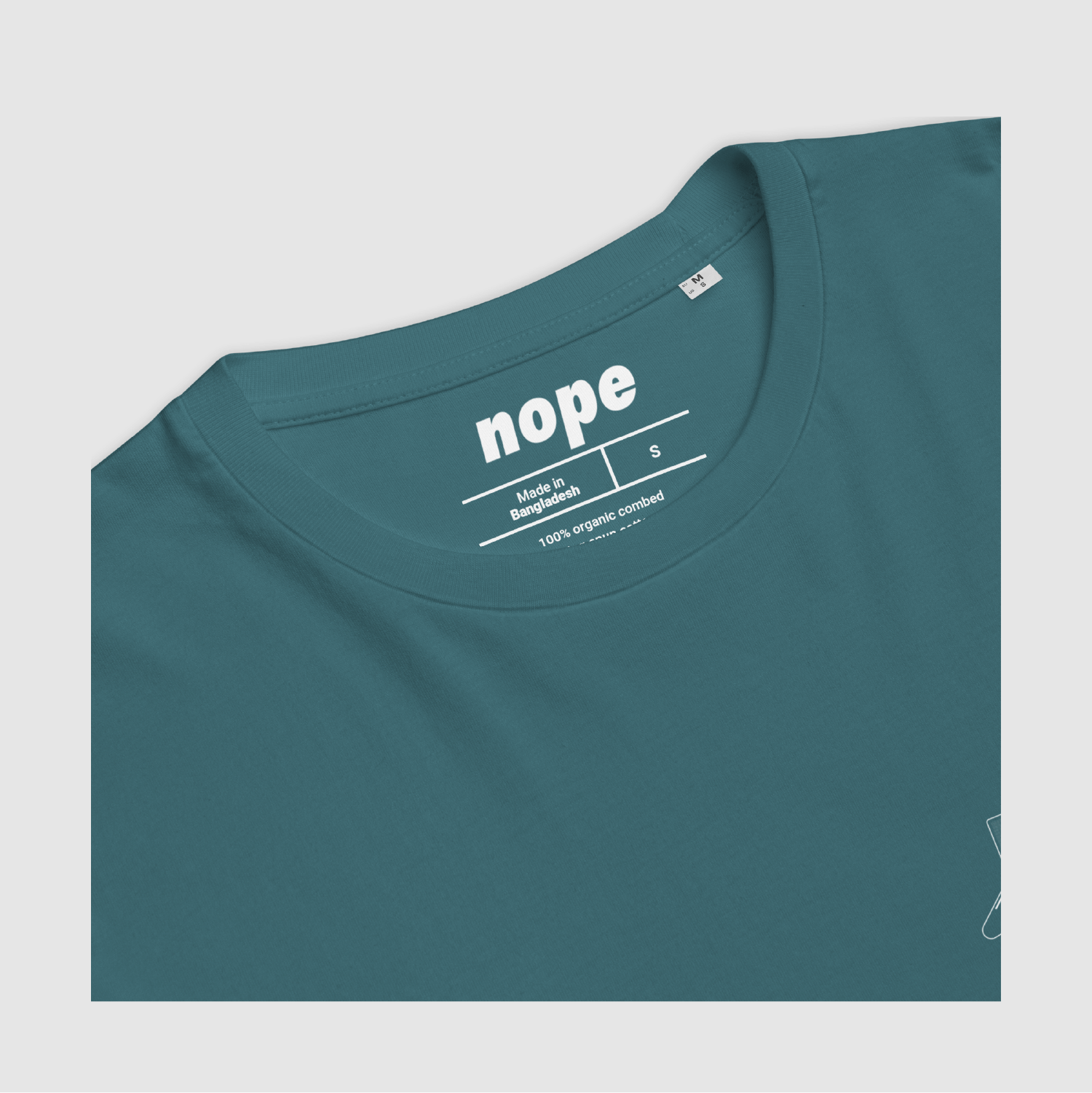 Nope MLLW Tee Detail Stargazer Blue: Detail shot of printed inner label and organic cotton fabric texture