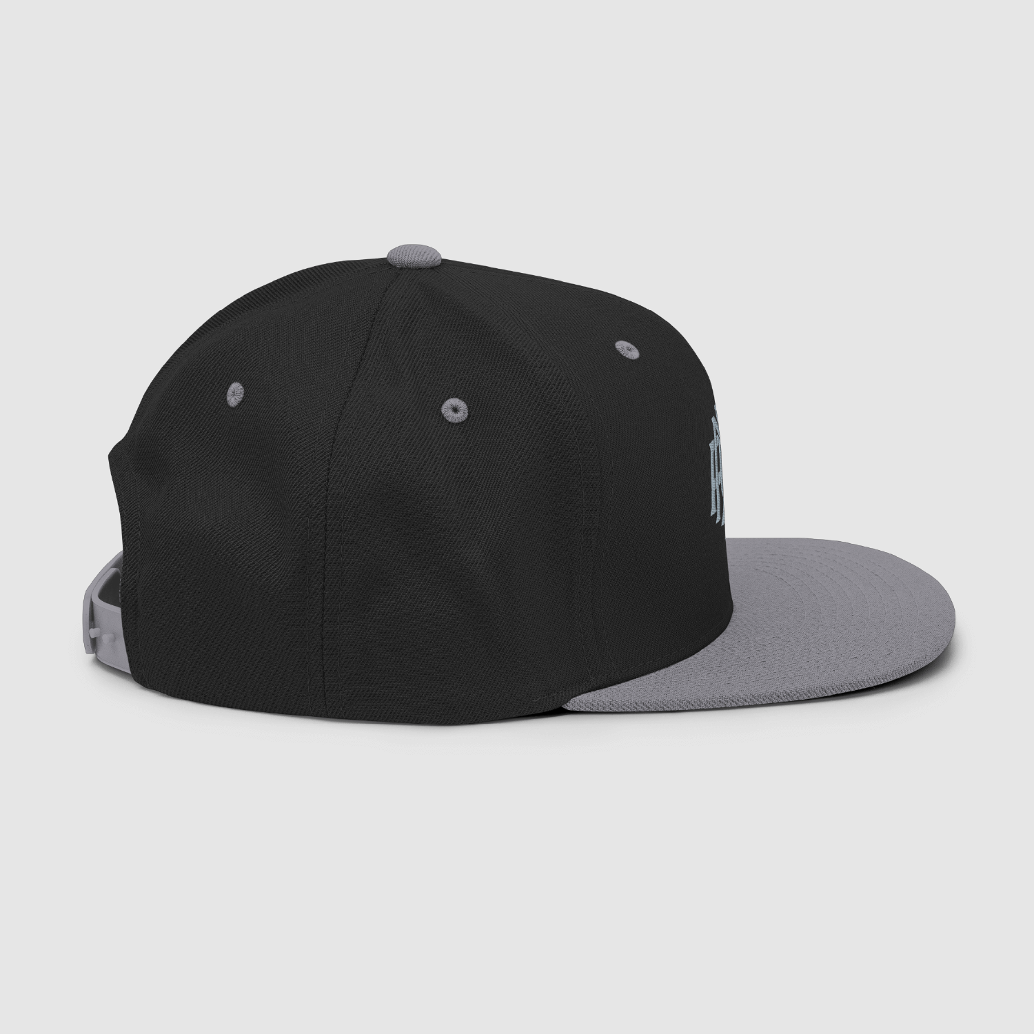 Side detail showing grey underbrim and embroidered eyelets on Nope cap