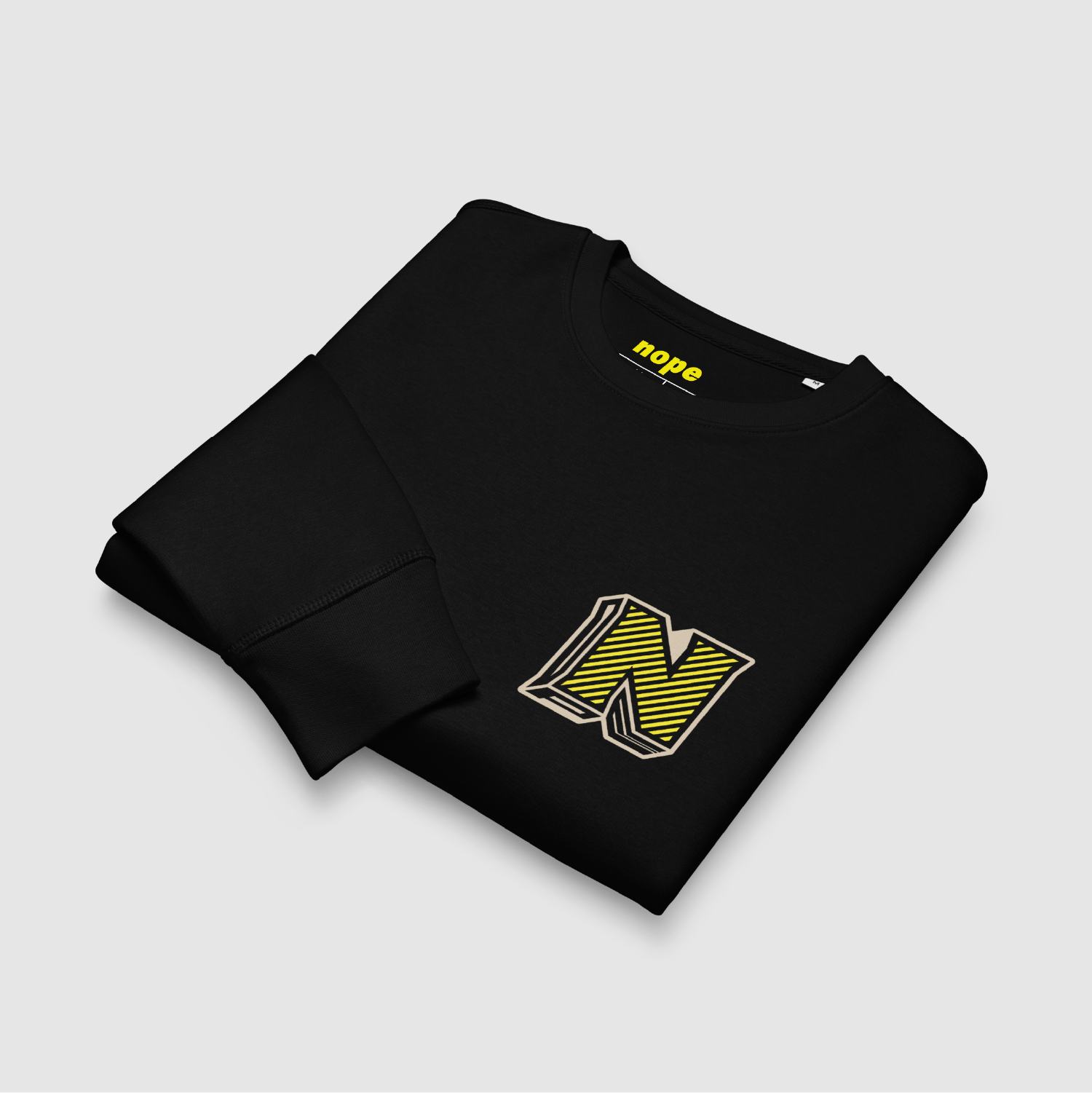Folded view of black sweatshirt showing yellow chest logo and yellow neck print