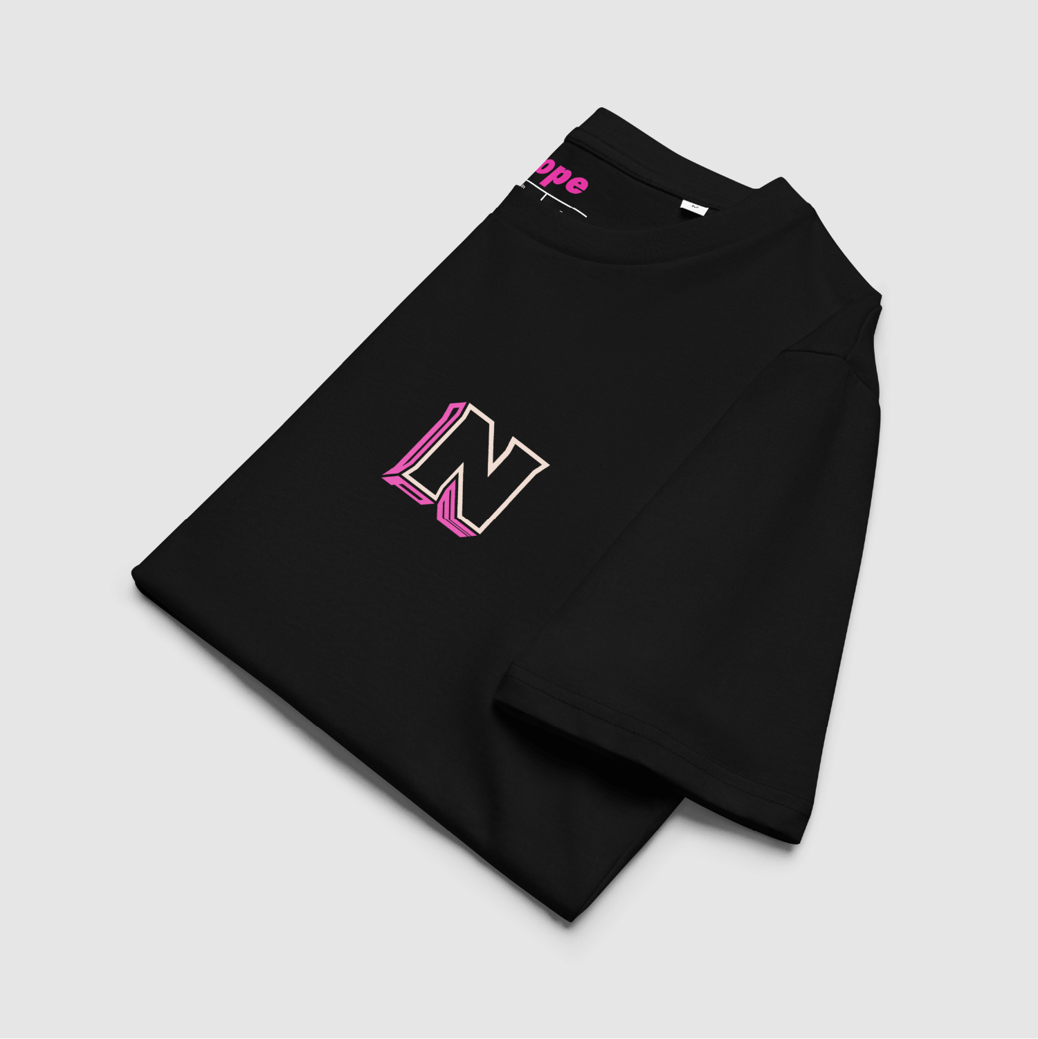 Folded view of Nope 3D Logo Tee in black – front logo and collar print shown